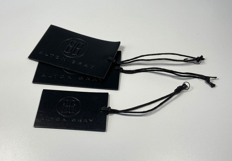 LEATHER SWING TAGS WITH RAISED DESIGN AND PU BACKING